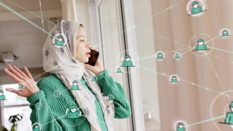 Animation-of-network-of-connections-over-biracial-woman-in-hijab-using-smartphone