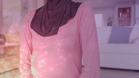 Animación-De-Puntos-De-Luz-Sobre-Una-Mujer-Birracial-Con-Hijab-Practicando-Yoga