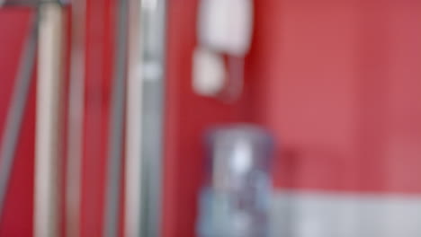 Fit-African-American-man-at-the-gym-lifting-weights,-with-copy-space