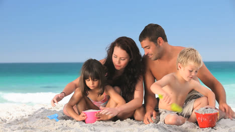 Nice-family-playing-with-the-sand