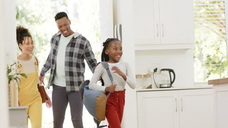 Happy-african-american-parents-and-daughter-coming-home-from-school,-slow-motion