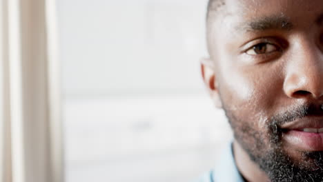 Half-portrait-of-happy-african-american-man-in-hospital-with-copy-space,-slow-motion