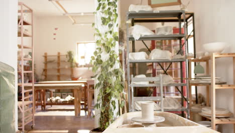 Desks,-shelfs-and-potter's-wheel-in-pottery-studio