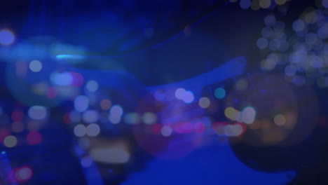 Caucasian-female-woman-playing-guitar-during-concert-over-city-at-night