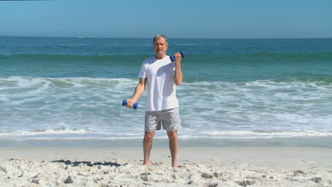 Mature-man-working-his-muscles-with-dumbbells