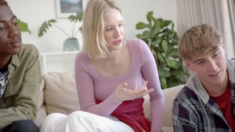 Thoughtful-diverse-group-of-teenage-friends-at-meeting-talking-at-home,-slow-motion