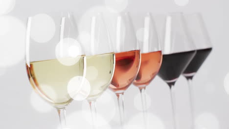 Composite-of-glasses-of-white,-rose-and-red-wine-over-white-background