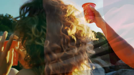 Animation-of-flag-of-italy-over-happy-diverse-friends-drinking-and-dancing-on-sunny-beach