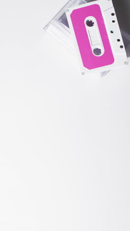 Vertical-video-of-retro-tape-with-pink-label-and-copy-space-on-white-background