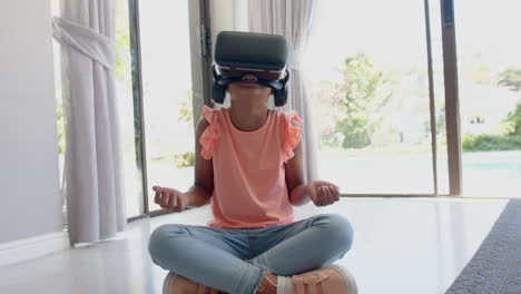 Happy-biracial-girl-wearing-vr-headset-using-virtual-interface-at-home,-slow-motion