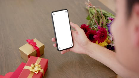 African-american-woman-holding-smartphone-with-copy-space-on-blank-screen