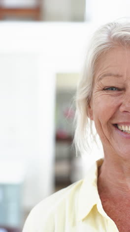 Half-face-of-happy-caucasian-senior-woman-standing-and-laughing-in-sunny-room,-slow-motion