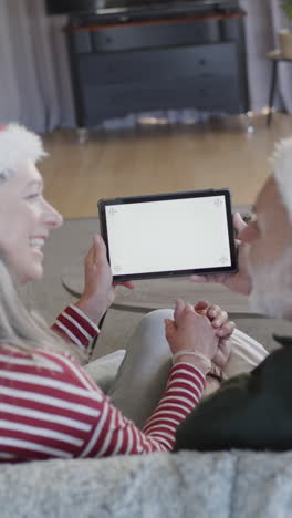 Vertical-video-of-senior-caucasian-couple-using-tablet-with-copy-space,-slow-motion