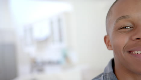 Portrait-of-happy-african-american-male-teenager-at-home,-copy-space,-slow-motion