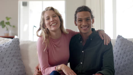 Portrait-of-happy-diverse-couple-talking-and-having-video-call-at-home,-slow-motion