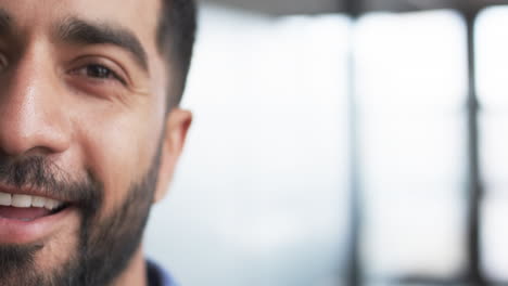 Close-up-of-smiling-young-Asian-business-man-with-a-beard-and-dark-hair,-with-copy-space