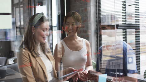 Young-Caucasian-woman-and-Asian-woman-discuss-business-documents-in-an-office-setting