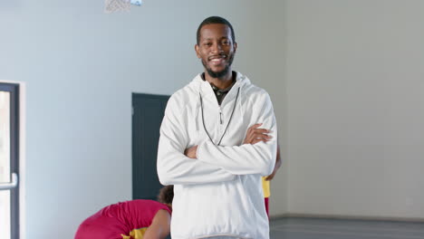 African-American-coach-stands-confidently-in-a-gym