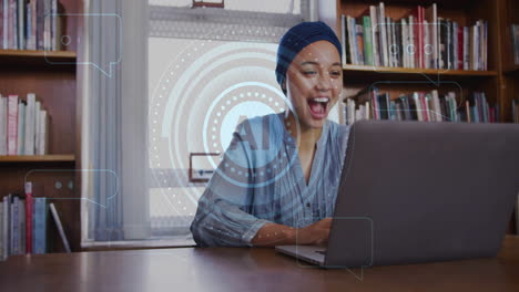 Animation-of-ai-text-and-data-over-biracial-female-student-in-hijab-with-laptop