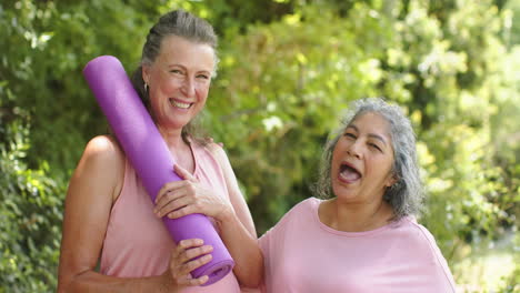 Caucasian-woman-and-senior-biracial-woman-share-a-laugh-outdoors