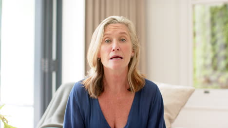 Senior-Caucasian-woman-gestures-during-a-conversation-at-home-on-a-video-call