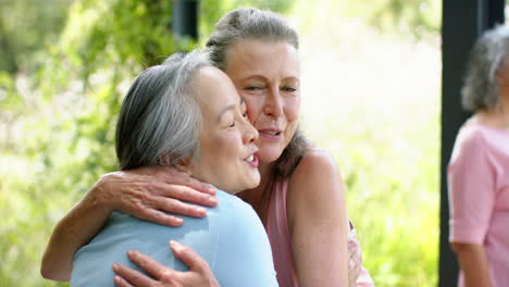 Senior-biracial-woman-enjoys-a-conversation-with-a-Caucasian-woman-outdoors