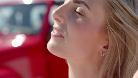 Close-up-of-a-young-Caucasian-woman-smiling-brightly-on-a-road-trip