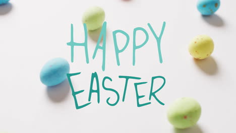 Animation-of-happy-easter-text-over-colourful-eggs-on-white-background