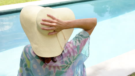 Senior-Caucasian-woman-enjoys-a-sunny-day-by-the-pool