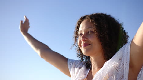 A-young-biracial-woman-with-curly-brown-and-green-hair-smiles-gently,-with-copy-space