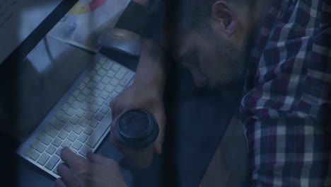 Animation-of-rain-on-window-over-tired-caucasian-casual-businessman-asleep-on-desk-with-computer