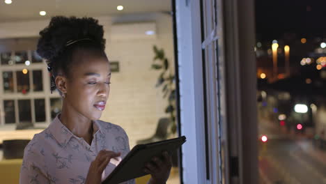 Young-African-American-woman-works-late-in-a-business-office,-with-copy-space