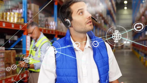 Animation-of-network-of-connections-with-icons-over-caucasian-male-workers-working-in-warehouse