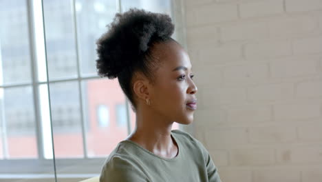 Young-African-American-woman-stands-in-a-bright-room,-with-copy-space