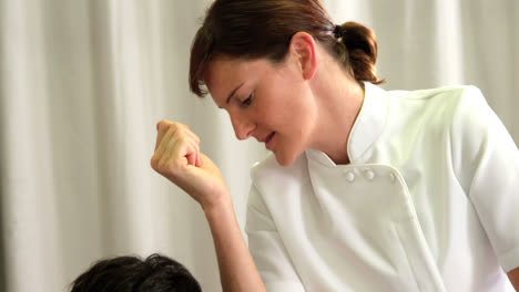 Physiotherapist-giving-back-massage-to-a-patient