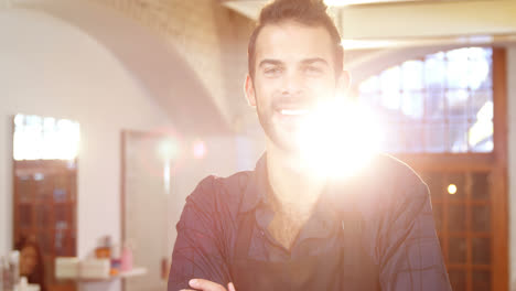 Male-hairdresser-smiling-in-hair-salon