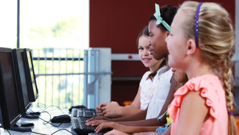 Schoolgirls-using-computer-in-classroom