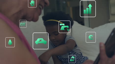 Animation-Von-Öko-Symbolen-Und-Datenverarbeitung-über-Einer-Afroamerikanischen-Frau-Mit-Einem-Mädchen,-Das-Ein-Smartphone-Verwendet
