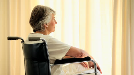 Mature-woman-in-a-wheelchair-thinking