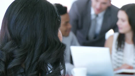 Confident-businesswoman-smiling-at-the-camera-in-office