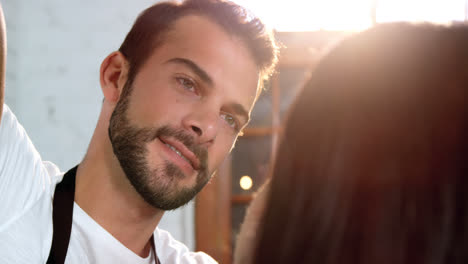 Woman-getting-his-hair-trimmed-with-scissor