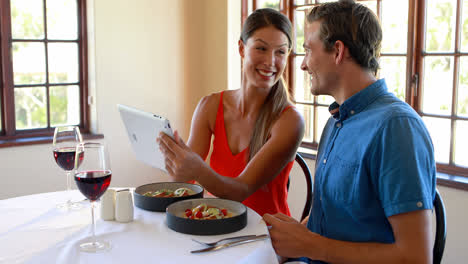 Pareja-Sonriente-Usando-Una-Tableta-Digital-En-El-Restaurante