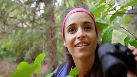 Close-up-of-hiker-using-binoculars