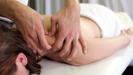 Physiotherapist-giving-back-massage-to-a-woman