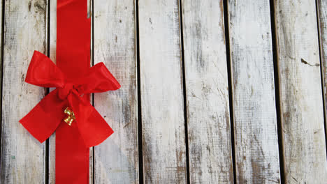 Red-ribbon-with-tied-knot-on-a-plank