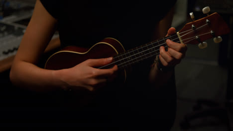 Woman-playing-a-guitar