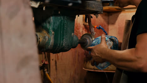 Glassblower-polishing-a-glass-bowl-with-machine