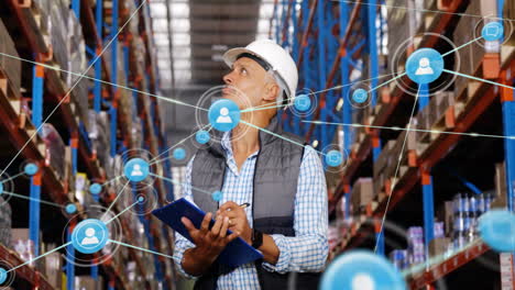 Animation-of-network-of-connections-with-icons-over-caucasian-male-worker-in-warehouse