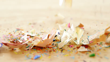 Various-colored-pencil-shavings-on-wooden-background