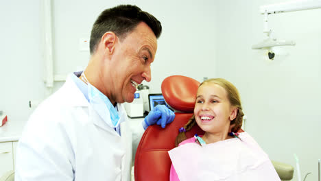 Dentist-interacting-with-young-patient